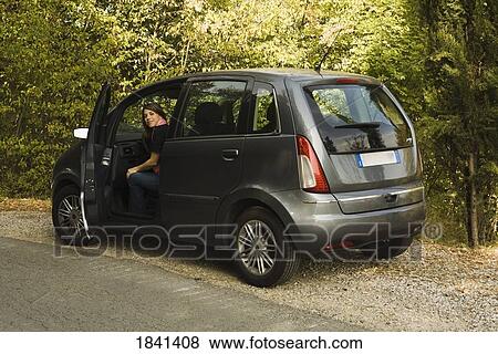 Stock Photo - Portrait Of Woman In Car On Roadside; Castello Di Verrazzano, Greti, Italy. Fotosearch