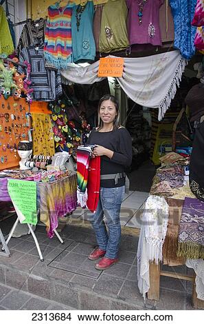 Picture - Portrait of woman standing in front of his souvenir shop; Guanajuato, Guanajuato State, Mexico. Fotosearch