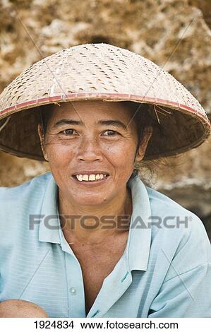 Picture - Portrait Of Woman Wearing Straw Hat. Fotosearch