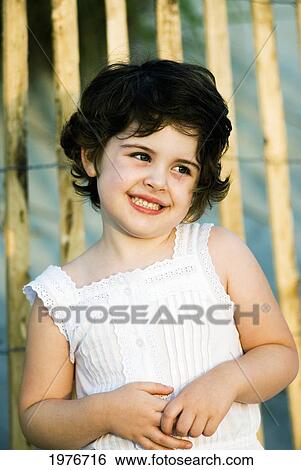 Stock Photograph - Portrait Of Young Dark-Haired Girl Smiling.. Fotosearch