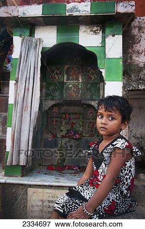 Stock Photo - Portrait Of Young Girl Sitting By Shrine; Varanasi, India. Fotosearch
