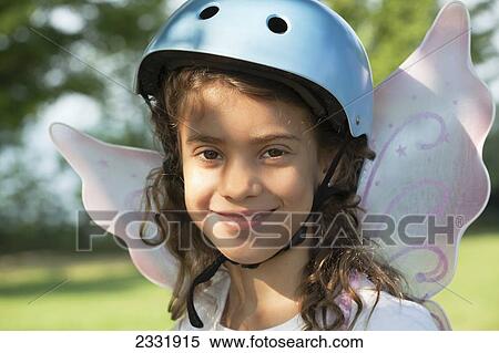 Portrait Of Young Girl Wearing A Bike Helmet And Fairy Wings; Whitby Ontario Canada View Large Photo Image Stock Photography - Portrait Of Young Girl Wearing A Bike Helmet And Fairy Wings; Whitby Ontario Canada. Fotosearch