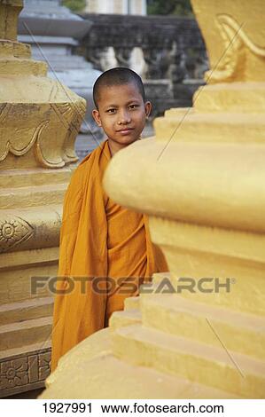 Stock Image - Portrait Of Young Monk Between Pillars. Fotosearch