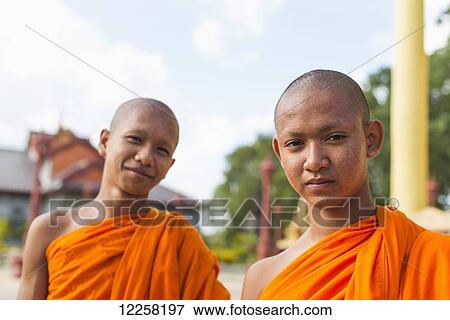 Stock Photo - Portrait of young monks outside a small temple near Sihanoukville City; Sihanoukville, Cambodia. Fotosearch