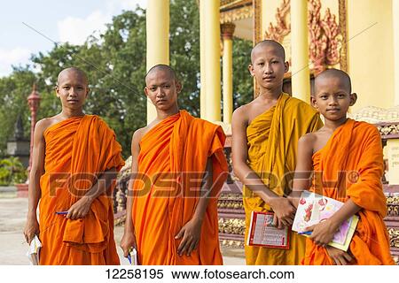 Stock Photography - Portrait of young monks outside a small temple near Sihanoukville City; Sihanoukville, Cambodia. Fotosearch