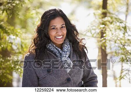 Portrait of young woman of South Asian ethnicity in winter clothing in Scanlon Creek Conservation Area; Ontario, Canada View Large Photo Image Picture - Portrait of young woman of South Asian ethnicity in winter clothing in Scanlon Creek Conservation Area; Ontario, Canada. Fotosearch