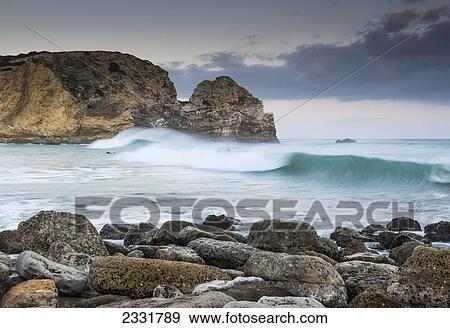 Stock Photo - Portugal, Algarve, Waves Crashing Into Rocks And Boulders On Shore; Sagres. Fotosearch