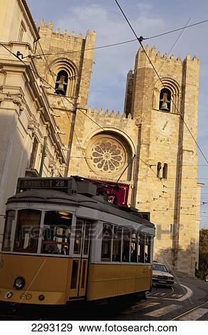 Stock Photo - Portugal, Tram passing Se Cathedral; Lisbon. Fotosearch