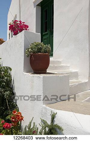 Stock Image - Potted plants and an old door; Artemonas, Sifnos, Cyclades, Greek Islands, Greece. Fotosearch
