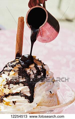 Pouring chocolate over a dessert; Bernese Oberland, Switzerland View Large Photo Image Stock Image - Pouring chocolate over a dessert; Bernese Oberland, Switzerland. Fotosearch
