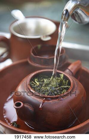 Stock Photo - Pouring Traditional Tea In Maokong Tea Growing Area. Fotosearch