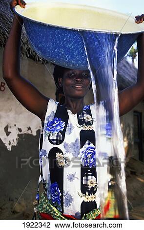 Stock Image - Pouring Water In Village. Fotosearch