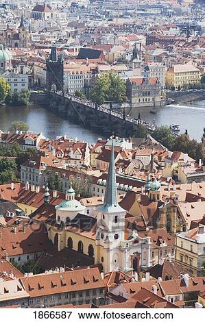 Stock Photo - Prague, Czech Republic; View Of Charles Bridge And Roof Tops. Fotosearch