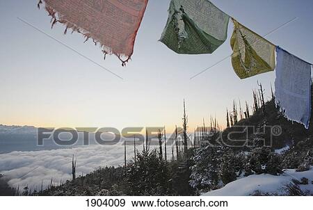 Stock Photo - Prayer Flags At Sunrise Over Himalayas, Paro Valley, Bhutan. Fotosearch