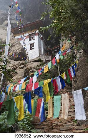 Stock Image - Prayer Flags Hanging In Front Of Tiger's Nest Monastery; Paro District Bhutan. Fotosearch