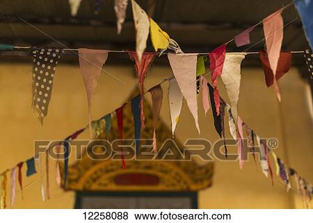 Stock Photo - Prayer flags in a local buddhist temple; Battambang, Cambodia. Fotosearch