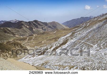 Prayer pieces of paper (Lungta) are spread by the wind across Tibetan mountains; Tibet View Large Photo Image Stock Photo - Prayer pieces of paper (Lungta) are spread by the wind across Tibetan mountains; Tibet. Fotosearch
