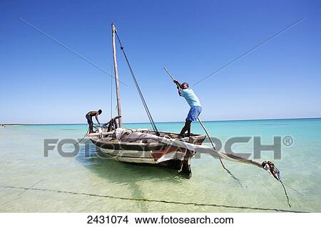 Preparing a boat close to the shore on the Indian ocean; Vamizi Island, Mozambique View Large Photo Image Picture - Preparing a boat close to the shore on the Indian ocean; Vamizi Island, Mozambique. Fotosearch