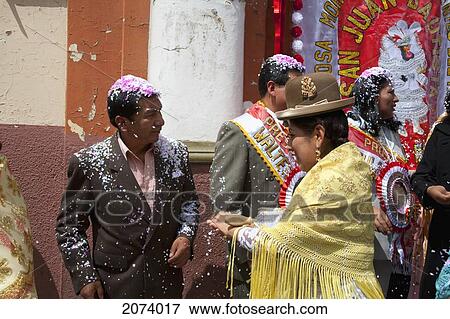 Stock Photo - Prestes (The Main Fiesta Sponsors Responsible Of Supplying With Drinks, Food, Coca Leaves, And The Ritual Ingredients Needed For The Celebration) Receive The Blessings From Members Of The Poderosa Morenada Promesantes Del Ni. Fotosearch