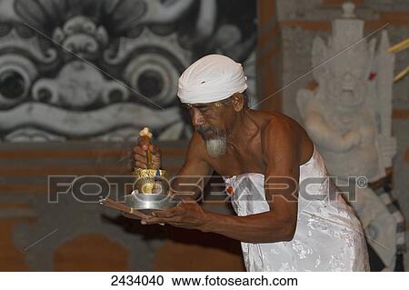 Priest carrying incense and a flower in a Kecak Dance performance telling a story of the Ramayana by the Sahadewa Dance Group, Batubulan, Bali, Indonesia View Large Photo Image Stock Image - Priest carrying incense and a flower in a Kecak Dance performance telling a story of the Ramayana by the Sahadewa Dance Group, Batubulan, Bali, Indonesia. Fotosearch