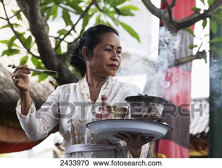 Priestess carrying incense and water in a Barong dance performance in Batubulan, Bali, Indonesia View Large Photo Image Stock Image - Priestess carrying incense and water in a Barong dance performance in Batubulan, Bali, Indonesia. Fotosearch