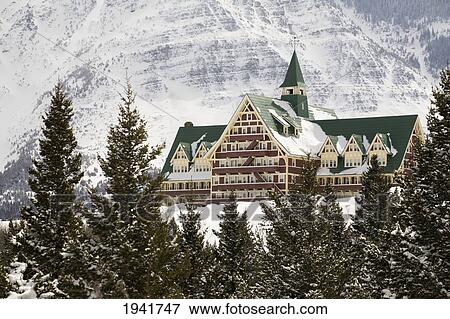 Prince Of Wales Hotel In The Winter Framed By Evergreen Trees And Snow Covered Mountains; Waterton Alberta Canada View Large Photo Image Stock Photo - Prince Of Wales Hotel In The Winter Framed By Evergreen Trees And Snow Covered Mountains; Waterton Alberta Canada. Fotosearch