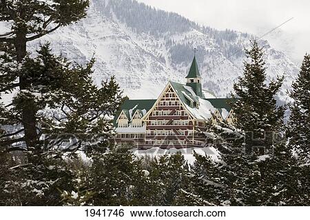 Prince Of Wales Hotel In The Winter Framed By Evergreen Trees And Snow Covered Mountains; Waterton Alberta Canada View Large Photo Image Stock Photograph - Prince Of Wales Hotel In The Winter Framed By Evergreen Trees And Snow Covered Mountains; Waterton Alberta Canada. Fotosearch