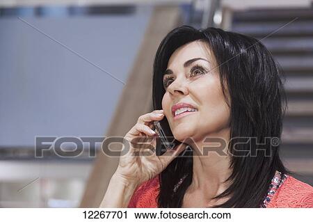 Professional businesswoman talking on her cell phone; Edmonton, Alberta, Canada View Large Photo Image Stock Image - Professional businesswoman talking on her cell phone; Edmonton, Alberta, Canada. Fotosearch