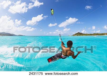 Professional kiteboarder Andre Philip kitesurfing over the crystal blue waters; Necker Island, British Virgin Islands View Large Photo Image Stock Photography - Professional kiteboarder Andre Philip kitesurfing over the crystal blue waters; Necker Island, British Virgin Islands. Fotosearch