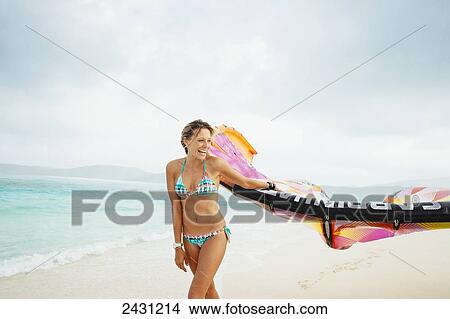 Professional kiteboarder Susi Mai on the beach enjoying the beautiful tropical white sands of the Caribbean; Necker Island, British Virgin Islands View Large Photo Image Picture - Professional kiteboarder Susi Mai on the beach enjoying the beautiful tropical white sands of the Caribbean; Necker Island, British Virgin Islands. Fotosearch