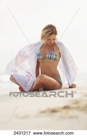 Stock Photo - Professional kiteboarder Susi Mai on the beach enjoying the beautiful tropical white sands of the Caribbean; Necker Island, British Virgin Islands. Fotosearch