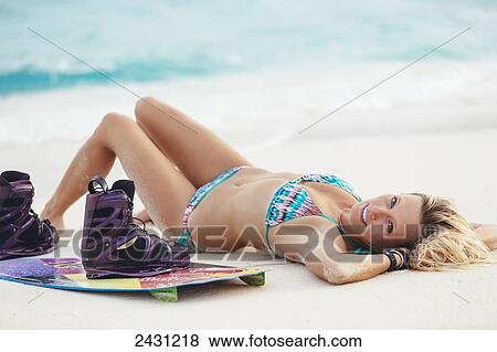 Stock Photo - Professional kiteboarder Susi Mai on the beach enjoying the beautiful tropical white sands of the Caribbean; Necker Island, British Virgin Islands. Fotosearch