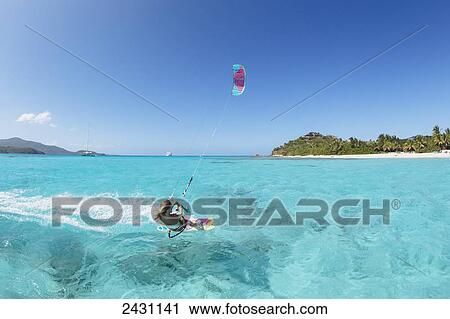 Professional kiteboarder Susi Mai kitesurfing over the crystal blue waters; Necker Island, British Virgin Islands View Large Photo Image Stock Image - Professional kiteboarder Susi Mai kitesurfing over the crystal blue waters; Necker Island, British Virgin Islands. Fotosearch