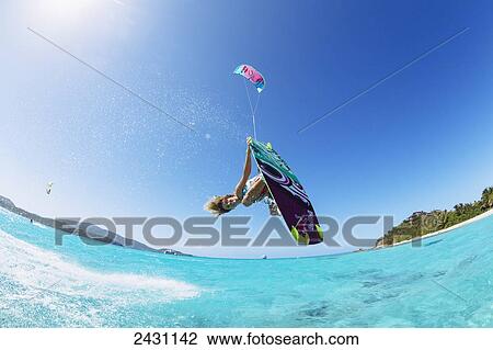Professional kiteboarder Susi Mai kitesurfing over the crystal blue waters; Necker Island, British Virgin Islands View Large Photo Image Stock Image - Professional kiteboarder Susi Mai kitesurfing over the crystal blue waters; Necker Island, British Virgin Islands. Fotosearch