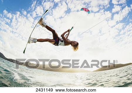 Stock Photo - Professional kiteboarder Susi Mai kitesurfing over the crystal blue waters; Necker Island, British Virgin Islands. Fotosearch