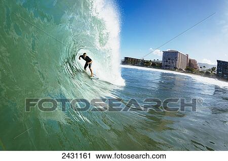 Professional surfer Dusty Payne gets barreled on beautiful blue wave; Maui, Hawaii, United States of America View Large Photo Image Stock Image - Professional surfer Dusty Payne gets barreled on beautiful blue wave; Maui, Hawaii, United States of America. Fotosearch