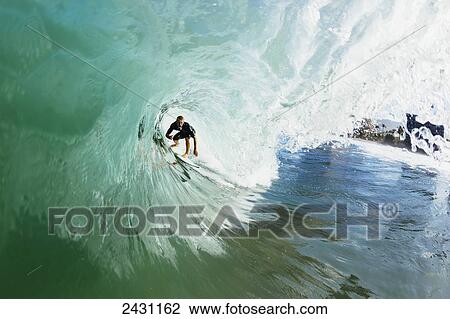 Professional surfer Dusty Payne gets barreled on beautiful blue wave; Maui, Hawaii, United States of America View Large Photo Image Stock Image - Professional surfer Dusty Payne gets barreled on beautiful blue wave; Maui, Hawaii, United States of America. Fotosearch
