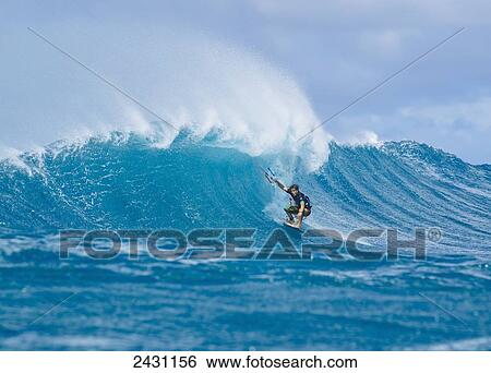 Stock Photograph - Professional surfer Jesse Richman gets barrelled on beautiful blue wave on Maui's North shore; Maui, Hawaii, United States of America. Fotosearch