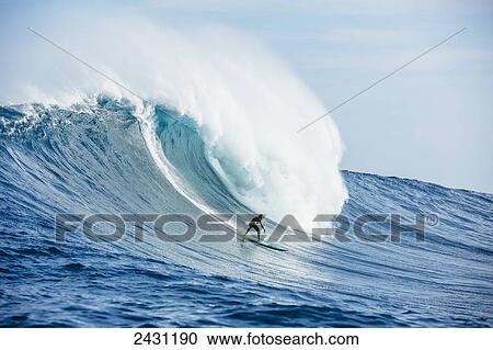 Stock Image - Professional surfer on large wave at the infamous big wave spot know as Jaws or Peahi; Maui, Hawaii, United States of America. Fotosearch