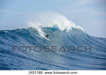 Stock Photo - Professional surfer on large wave at the infamous big wave spot know as Jaws or Peahi; Maui, Hawaii, United States of America. Fotosearch