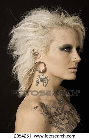 Stock Image - Profile Of Blonde Women With Piercings And Tattoos. Fotosearch