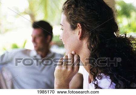 Profile Of Brunette Woman, Man Blurred In Background. View Large Photo Image Stock Image - Profile Of Brunette Woman, Man Blurred In Background.. Fotosearch