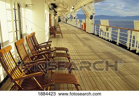 Stock Image - Promenade Deck With Empty Wooden Sun Loungers. Fotosearch