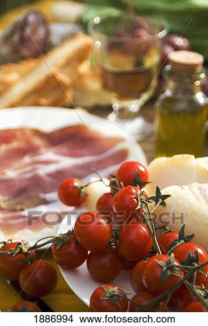 Prosciutto Ham, Cheese, Tomatoes, White Wine And, Bread And Olive Oil, Close Up View Large Photo Image Picture - Prosciutto Ham, Cheese, Tomatoes, White Wine And, Bread And Olive Oil, Close Up. Fotosearch