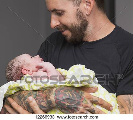 Proud father holding newborn baby girl in delivery room; Edmonton, Alberta, Canada View Large Photo Image Stock Image - Proud father holding newborn baby girl in delivery room; Edmonton, Alberta, Canada. Fotosearch