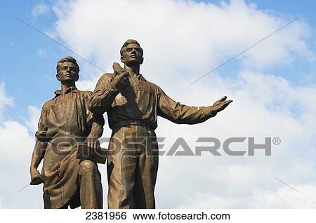 Stock Photograph - Public Soviet statue of male workers; Vilnius, Lithuania. Fotosearch