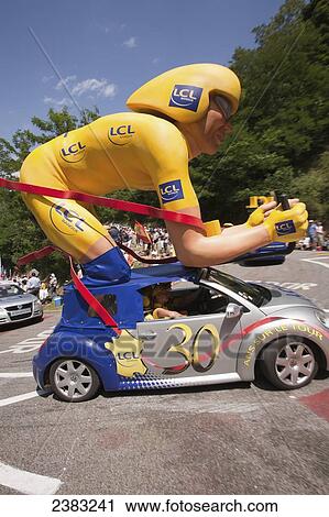 Stock Image - Publicity caravans on the road handing out gifts to the crowd at the Tour de France; Pyrenees, France. Fotosearch