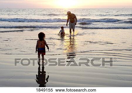 Puerto Vallarta, Mexico; Father On Beach With Children At Sunset View Large Photo Image Stock Photography - Puerto Vallarta, Mexico; Father On Beach With Children At Sunset. Fotosearch