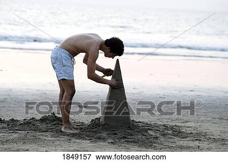 Puerto Vallarta, Mexico; Young Man Building Sand Sculpture View Large Photo Image Stock Photo - Puerto Vallarta, Mexico; Young Man Building Sand Sculpture. Fotosearch