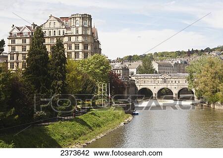Stock Image - Pulteney Bridge, River Avon and Empire Hotel; Bath, England. Fotosearch